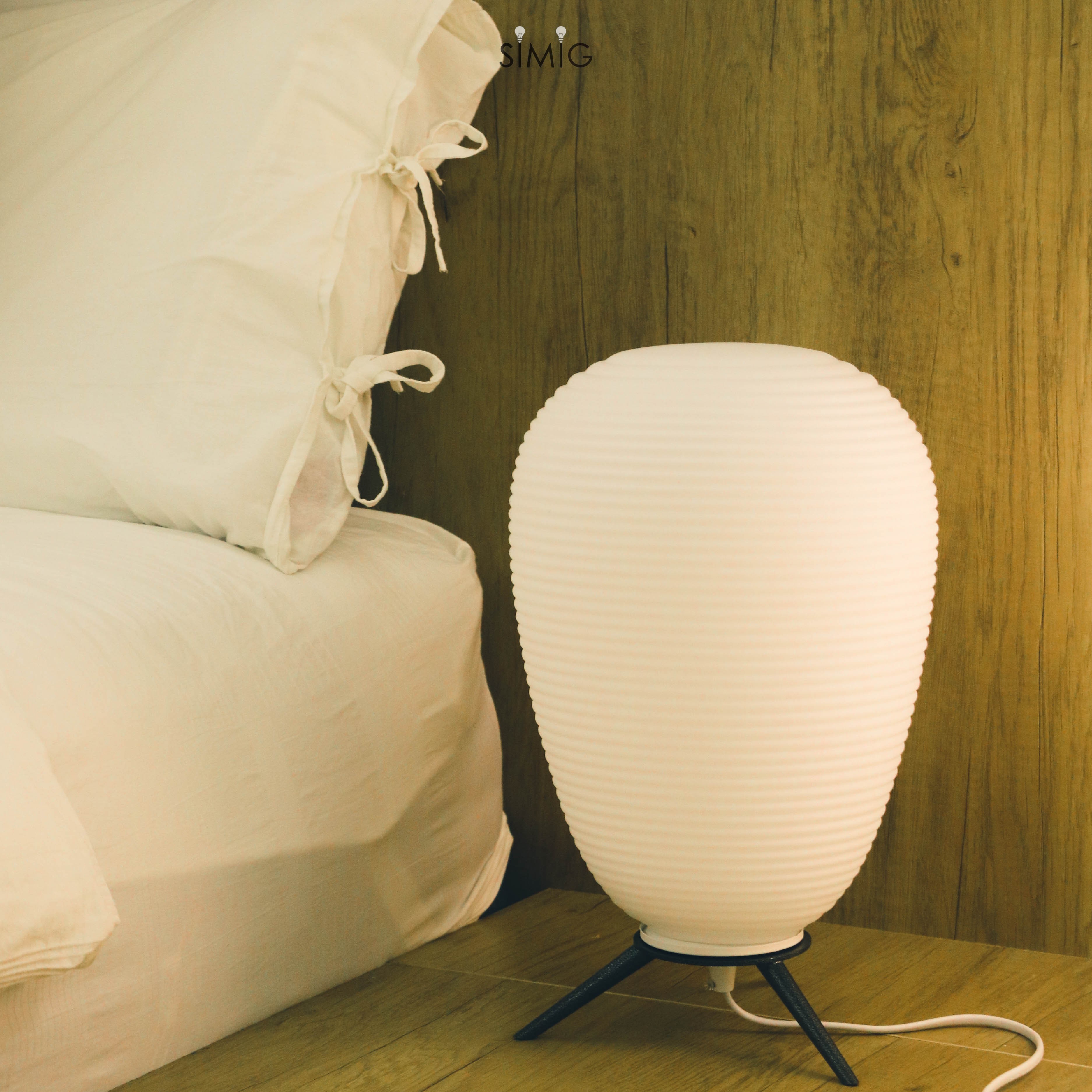 Lamp beside bed in bedroom setting
