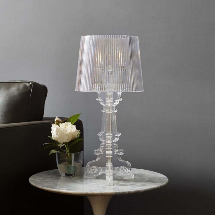 Clear Bourgie lamp on a side table with decor