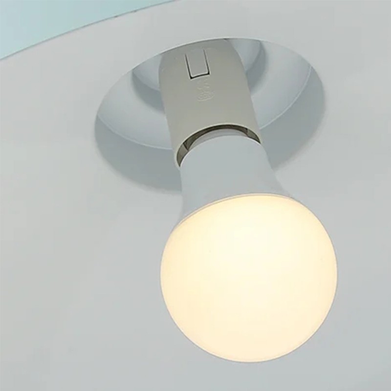 Primo piano del portalampada a sospensione e dettaglio della lampadina accesa.