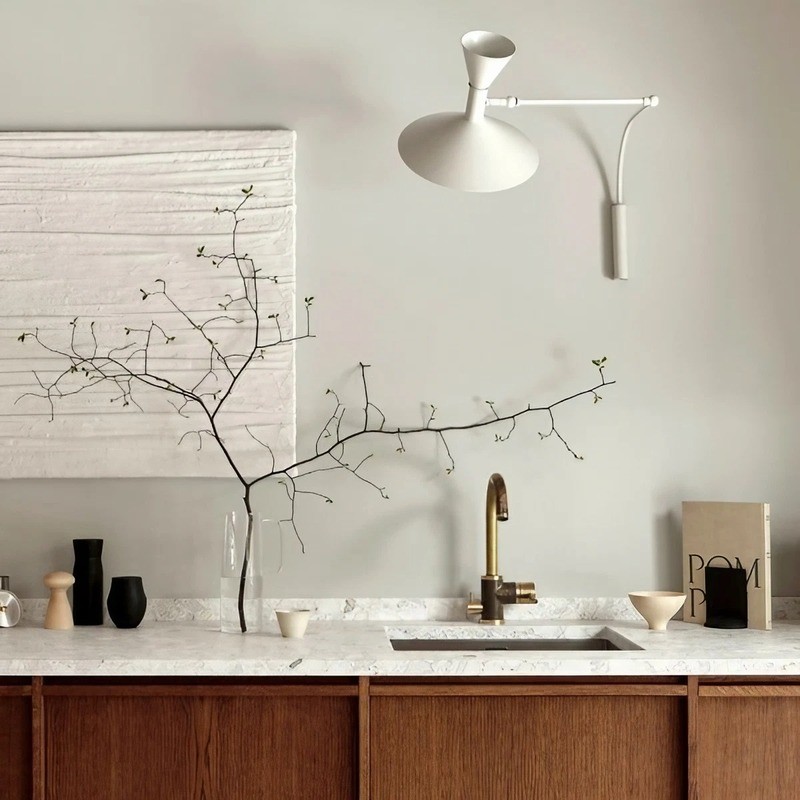 White adjustable wall lamp above a kitchen counter or vanity