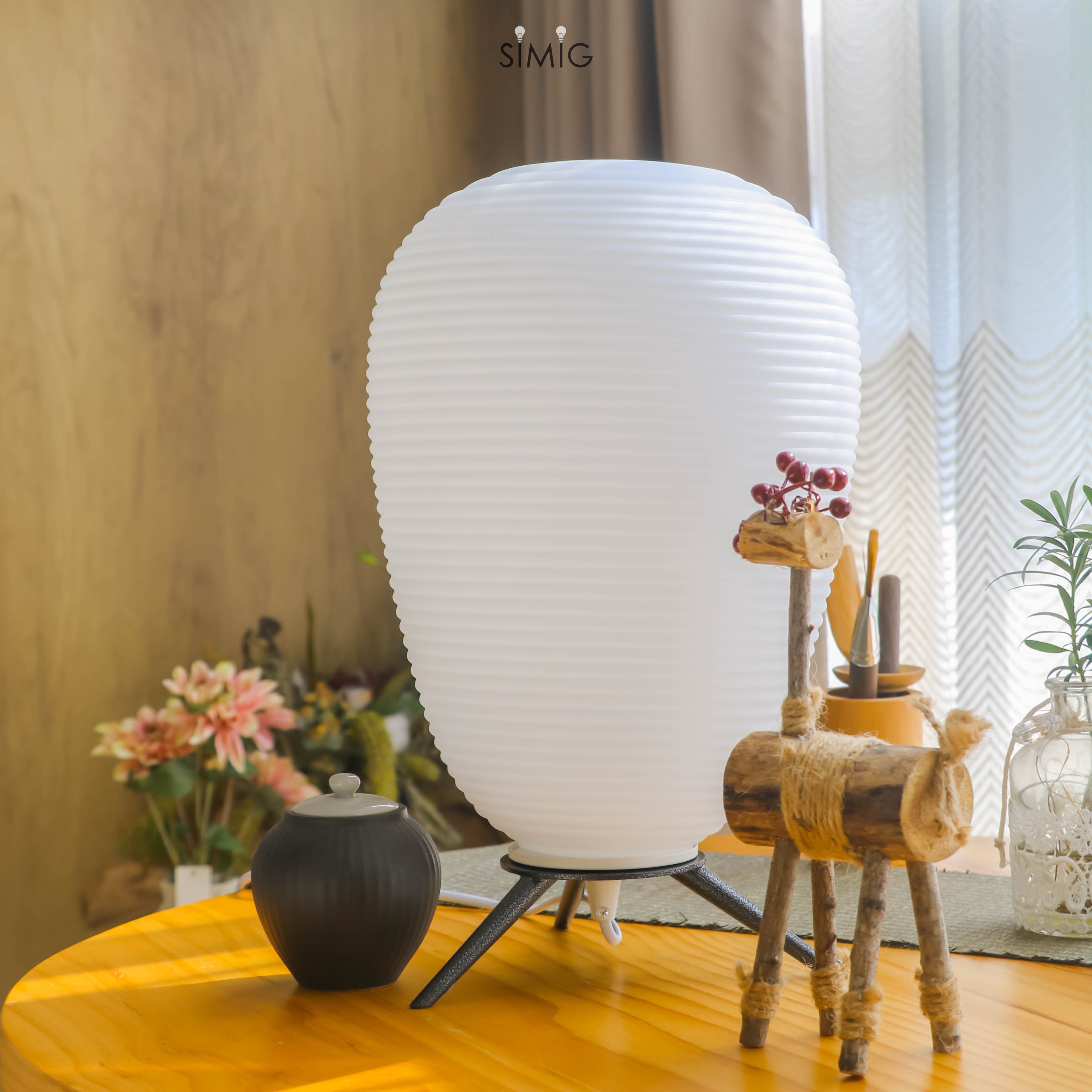 Lamp centered on tabletop with decorative props