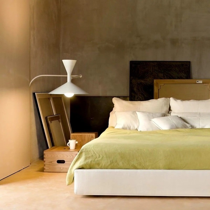 Adjustable wall lamp installed beside a bed