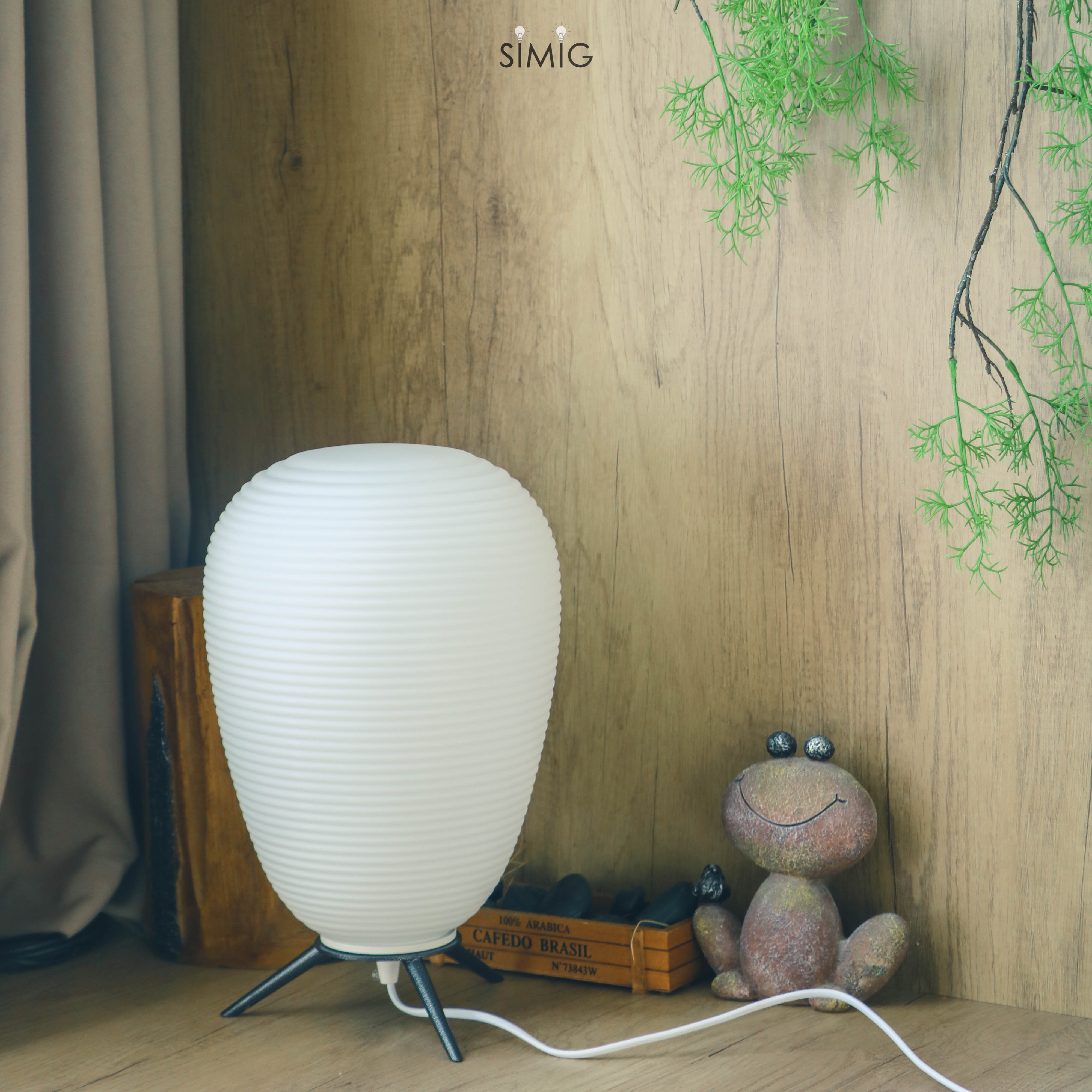 Lamp in staged room scene with visible cord
