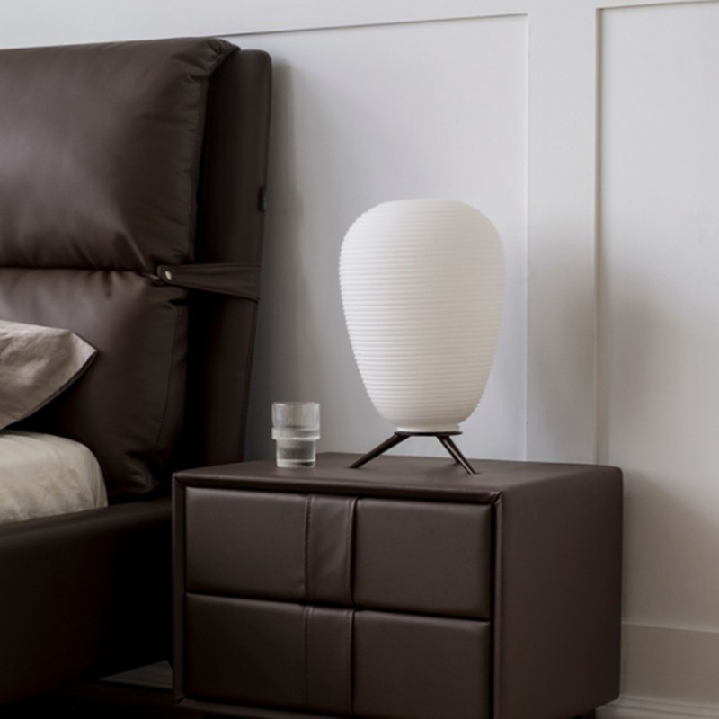 Lamp on bedside table in bedroom scene
