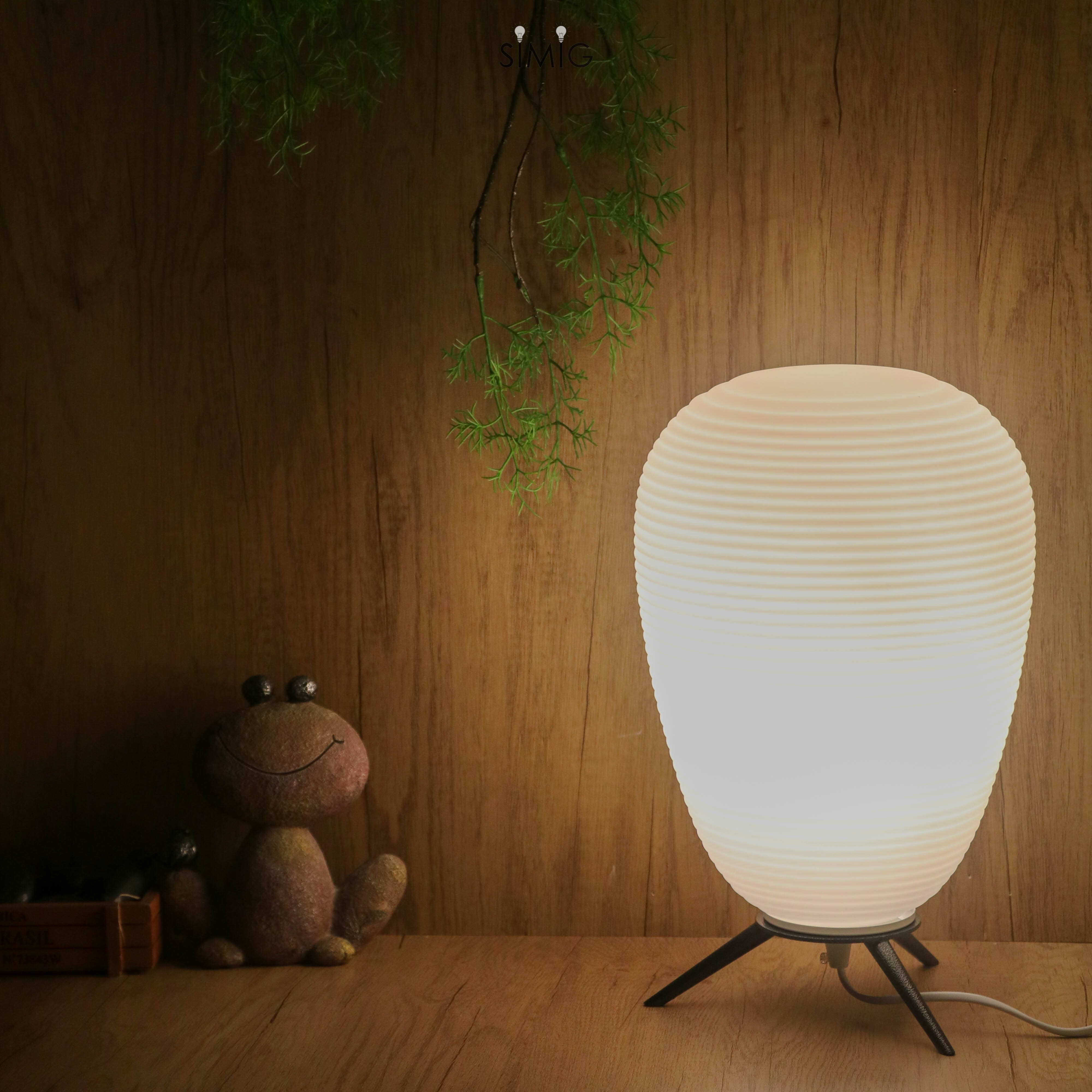 Lit lamp in a darker warm room scene