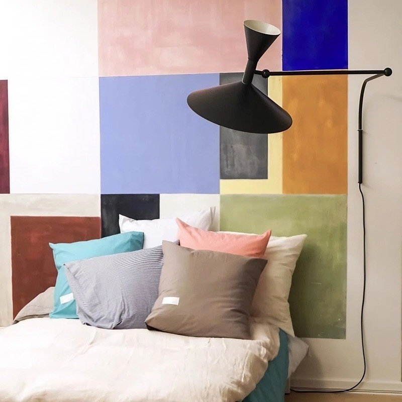Black wall lamp in a colorful bedroom or lounge scene