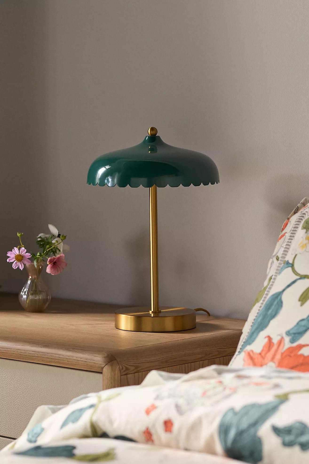 Grön Rayla-skrivbordslampa på ett nattduksbord i en sovrumsscen