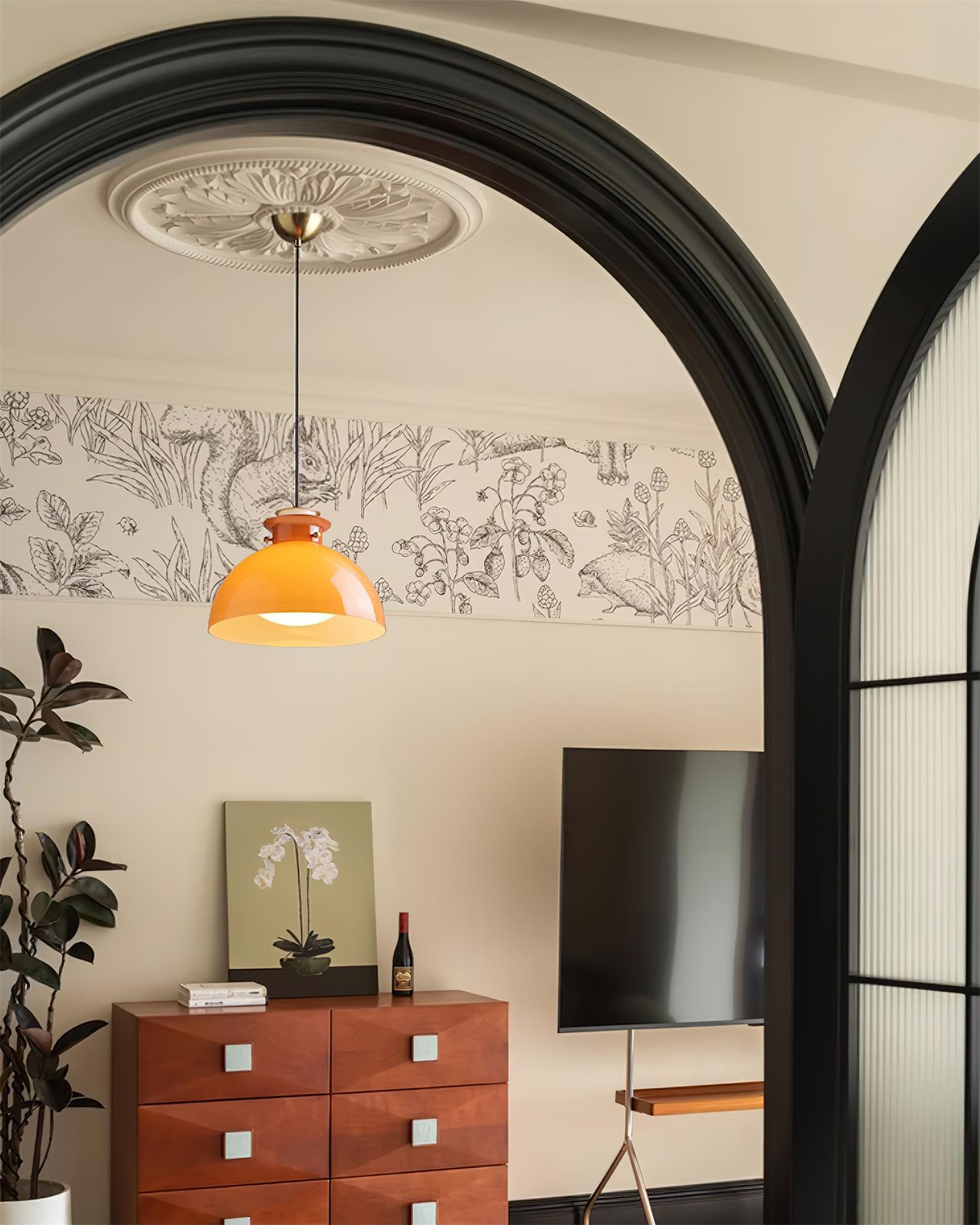 Pomarańczowa lampa wisząca Glebe widziana przez łuk