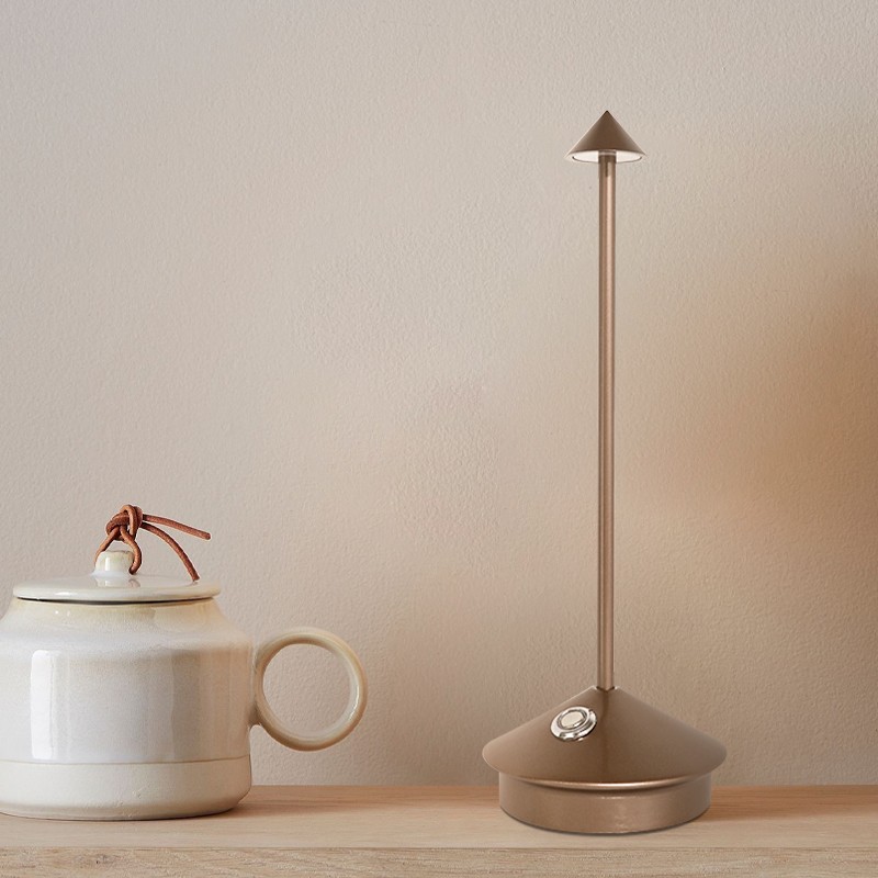 Pina lamp on a tabletop with a mug and decor