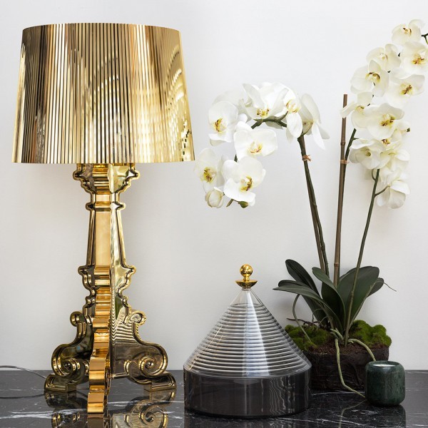 Orange Bourgie lamp with flowers on tabletop