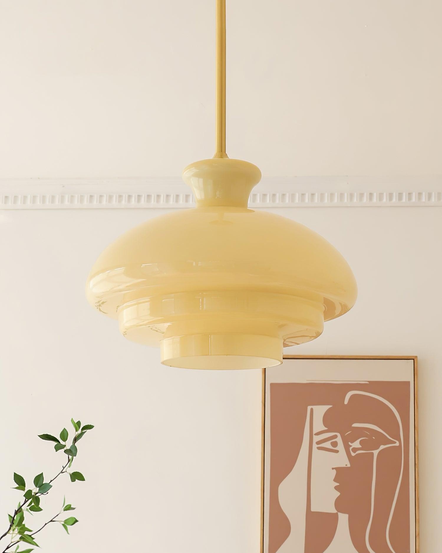 Lampa wisząca z żółtego szkła w miękko urządzonym pokoju