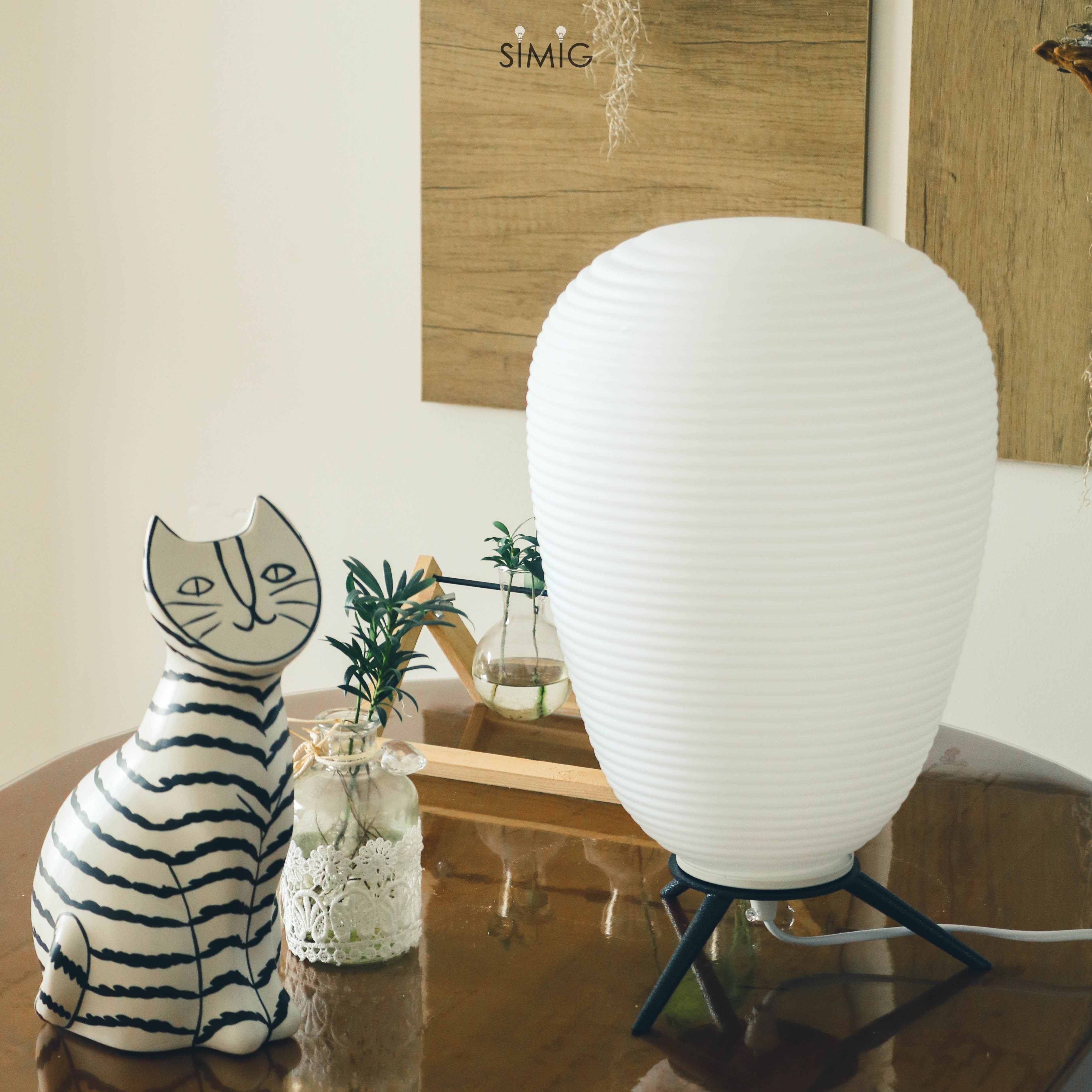 Lamp on tabletop with decor, product on right side