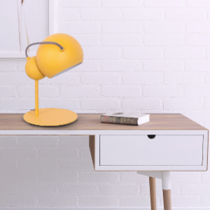 Gelbe kugelförmige Tischlampe auf einem Schreibtisch oder Nachttisch