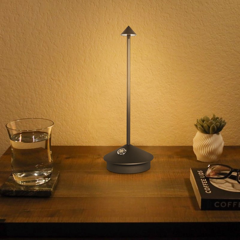 Illuminated Pina lamp on a wooden tabletop