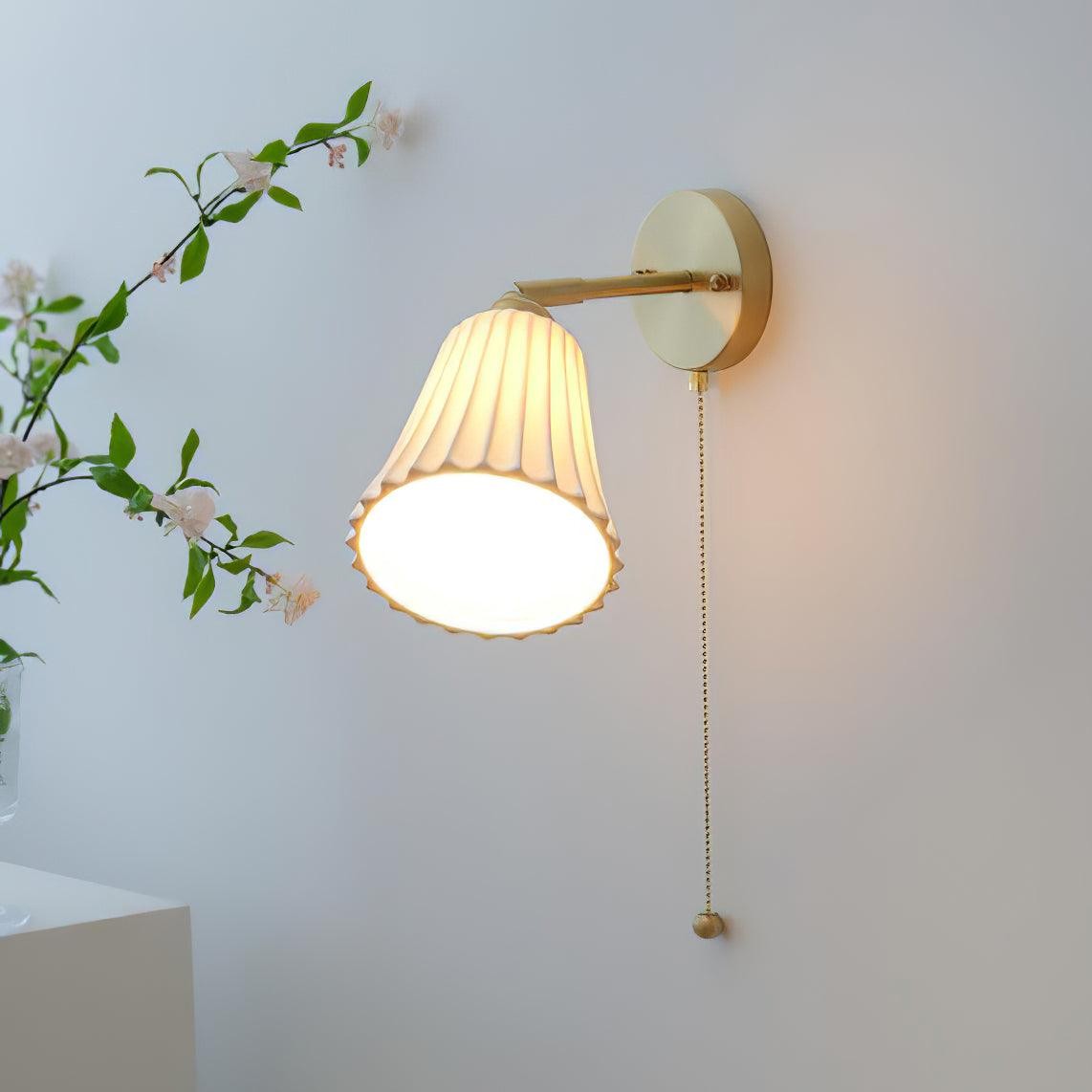 Lampa ścienna zainstalowana z dobrze widocznym abażurem i sznurkiem
