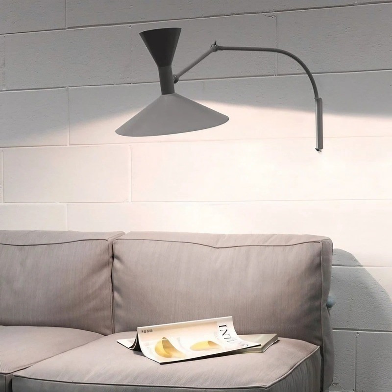 Grey or white adjustable wall lamp mounted above a sofa
