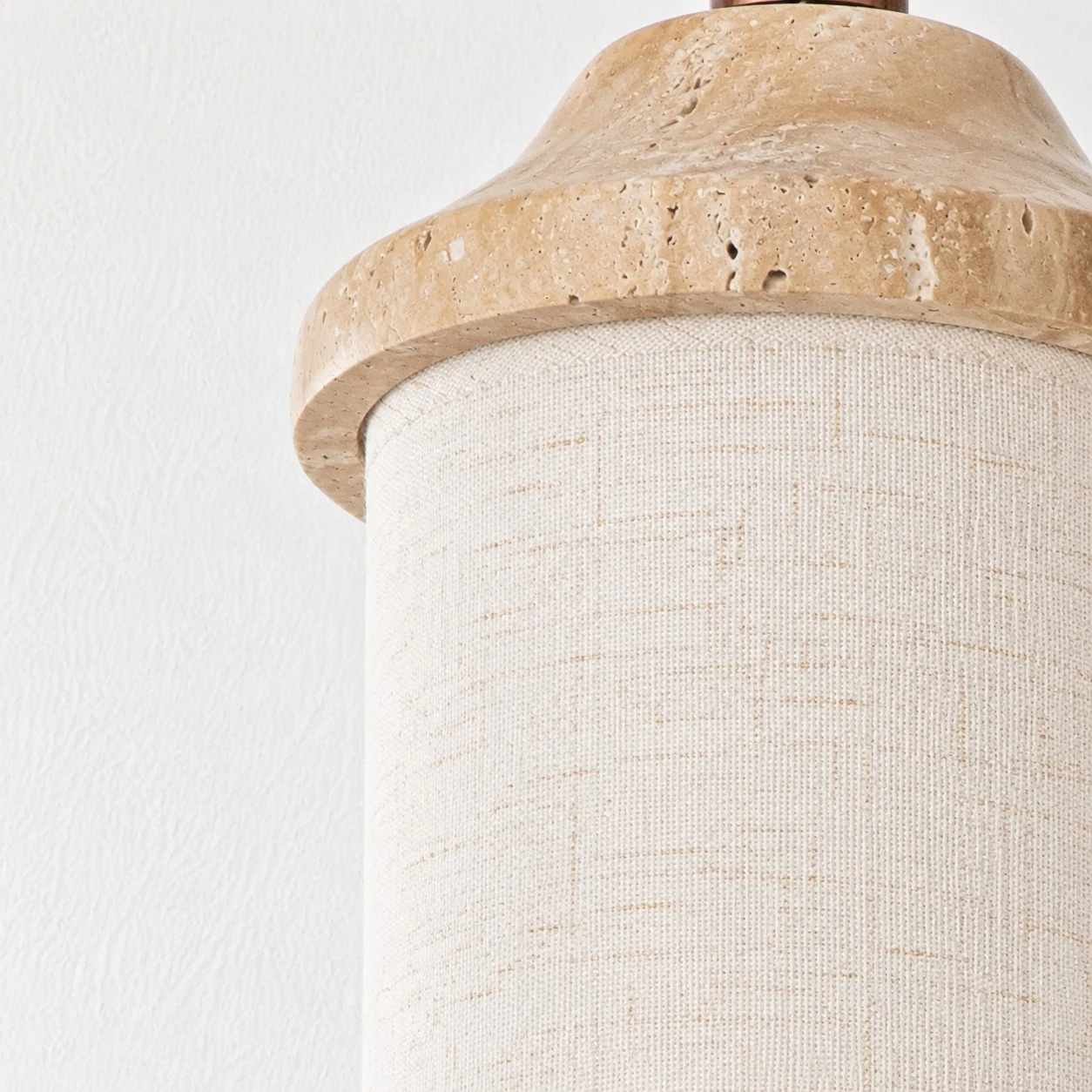 Fabric shade texture beneath the natural stone cap