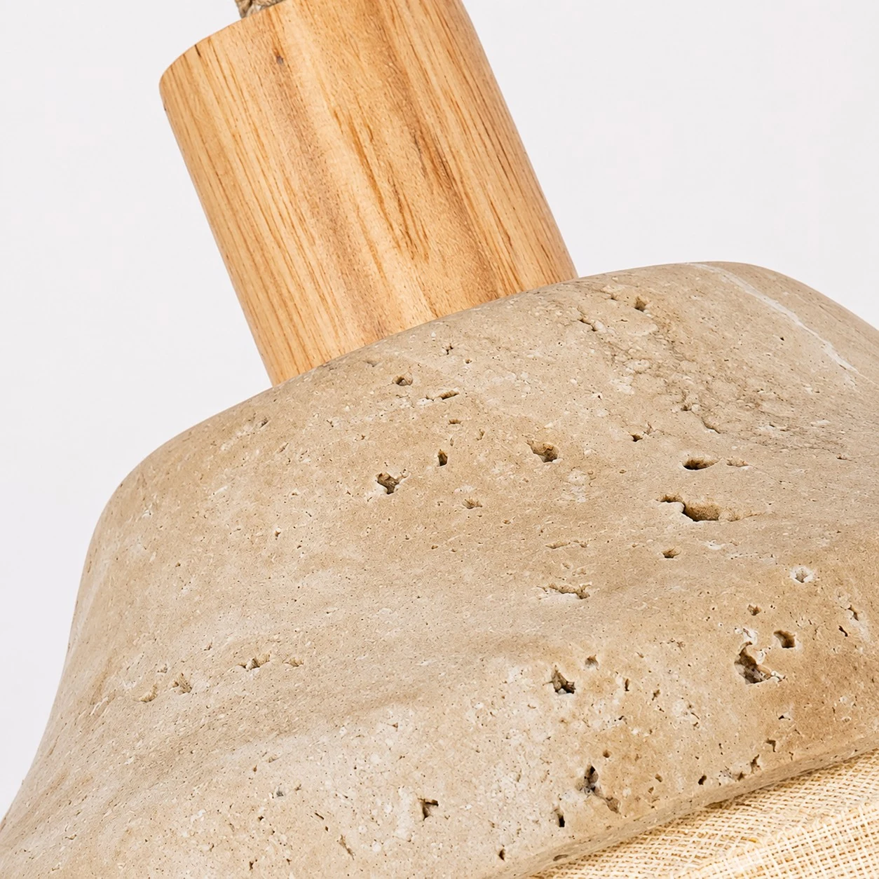 Travertine-like stone pore texture and wood stem close-up