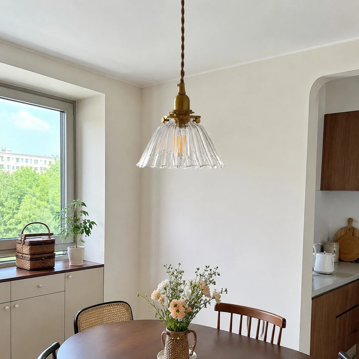 Clear ribbed pendant near a window corner