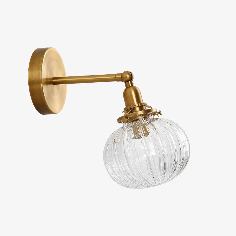 Antique brass ribbed glass wall sconce on a clean background