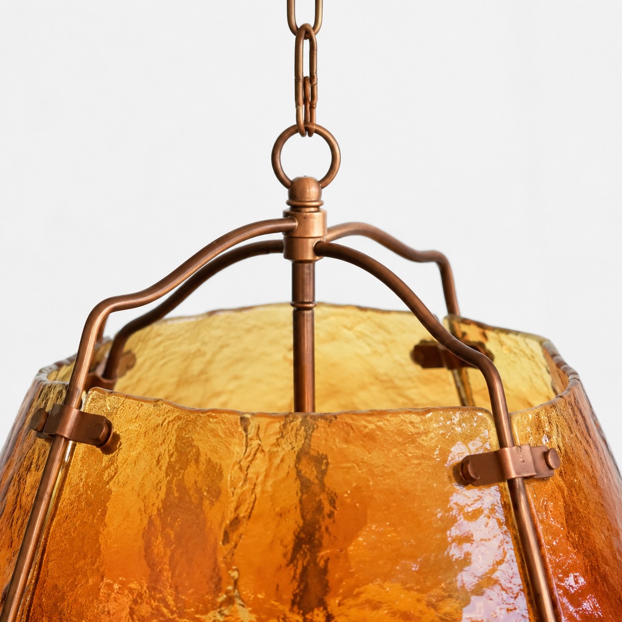 Pendant chain and curved metal frame close-up