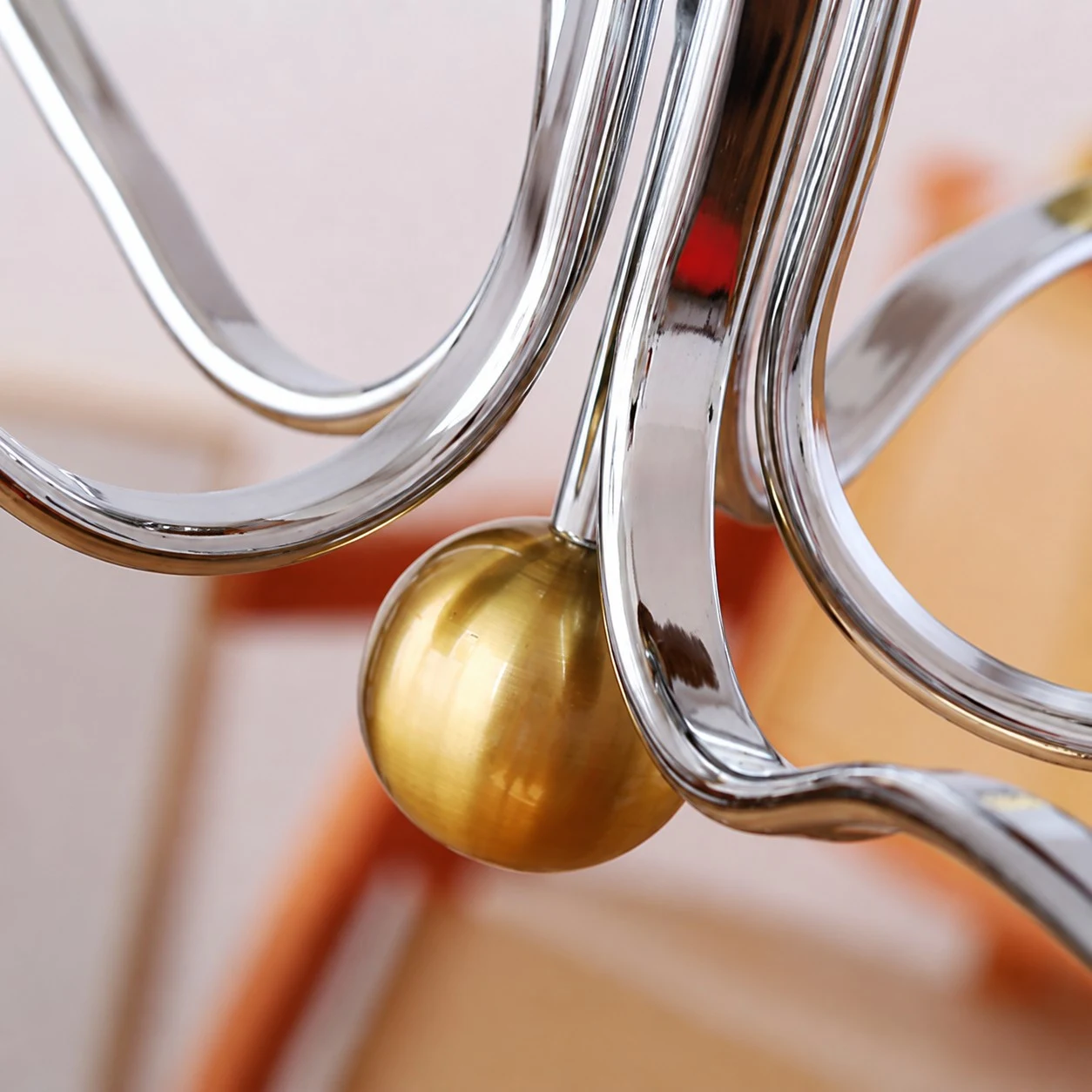 Close view of the polished metal arm and warm brass accent