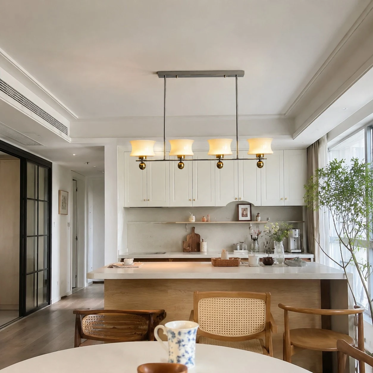 Linear cream glass chandelier over a kitchen island