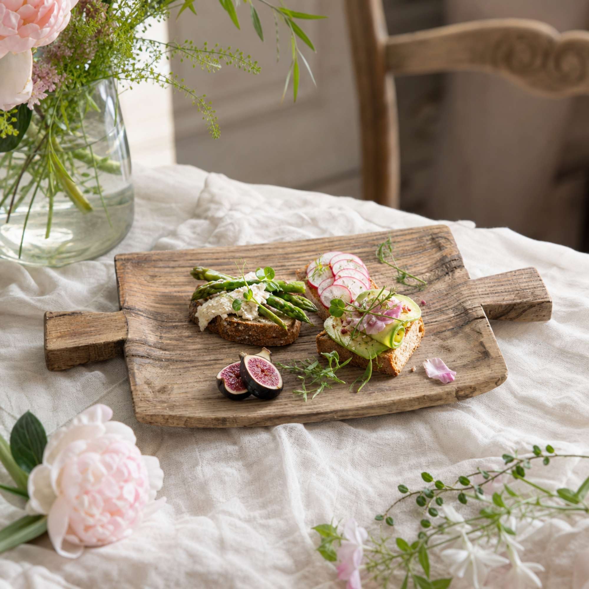 Rustic wood serving tray styled with brunch and flowers