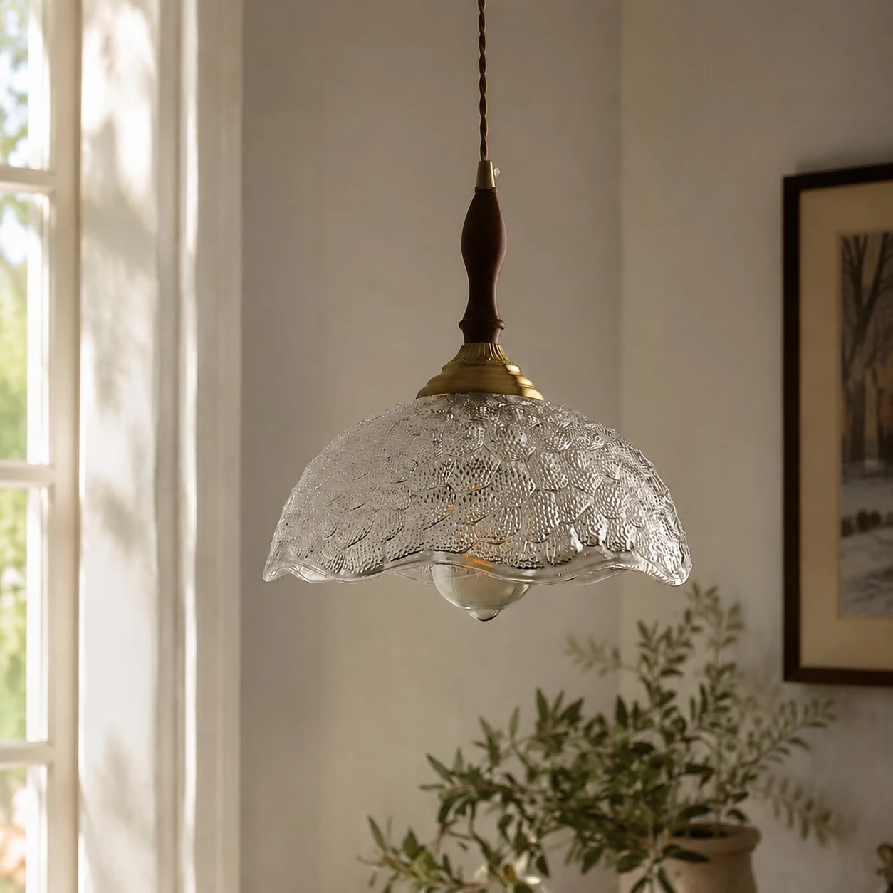 Clear glass pendant with cord and brass cap