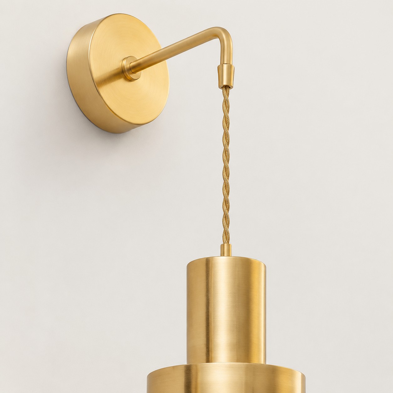Chain suspended brass wall sconce with round wall base