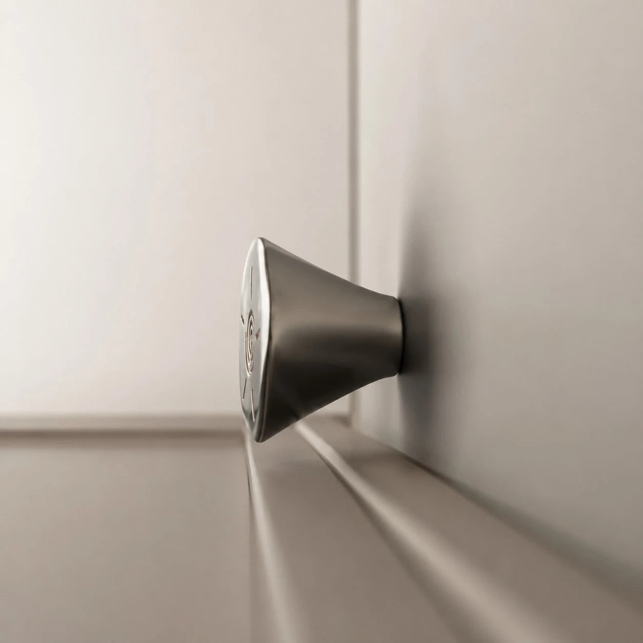 Side view of titanium silver knob on cabinetry