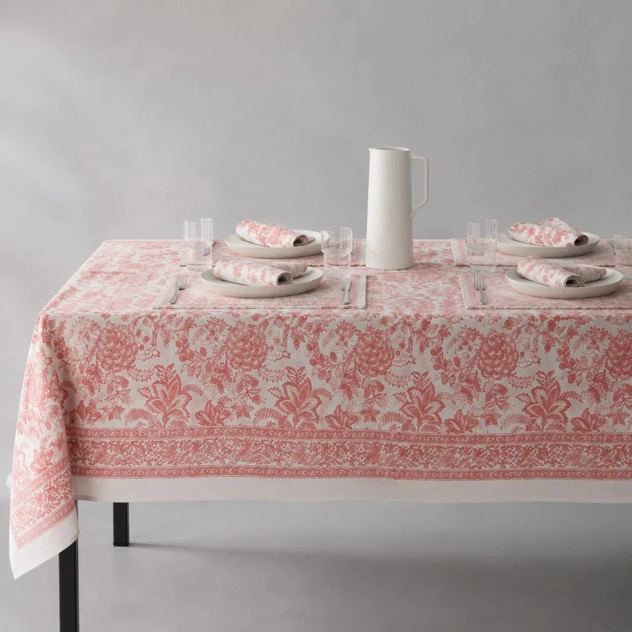 Soft coral floral tablecloth on a dining table