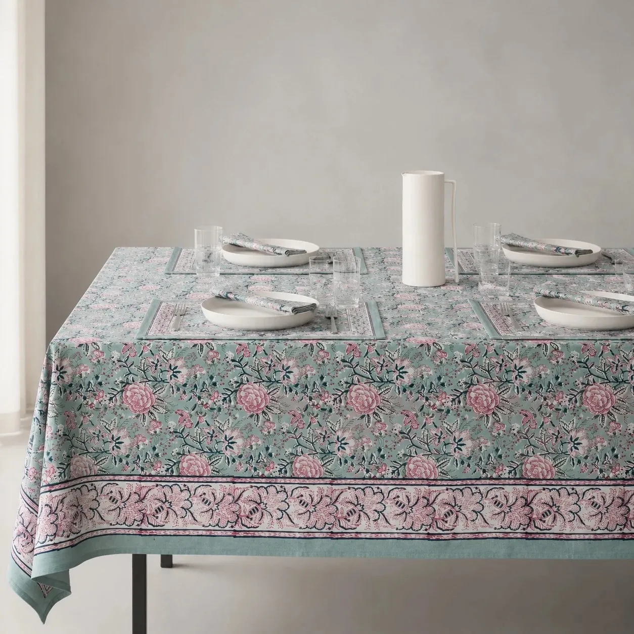 Sage green floral tablecloth on a dining table