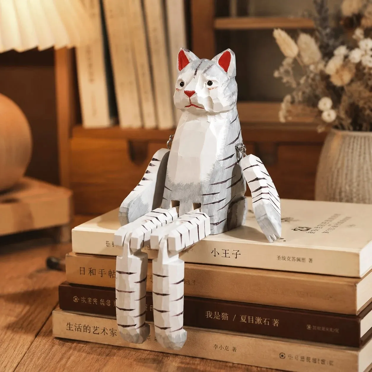 Hand-carved wooden cat ornament styled on a tabletop edge