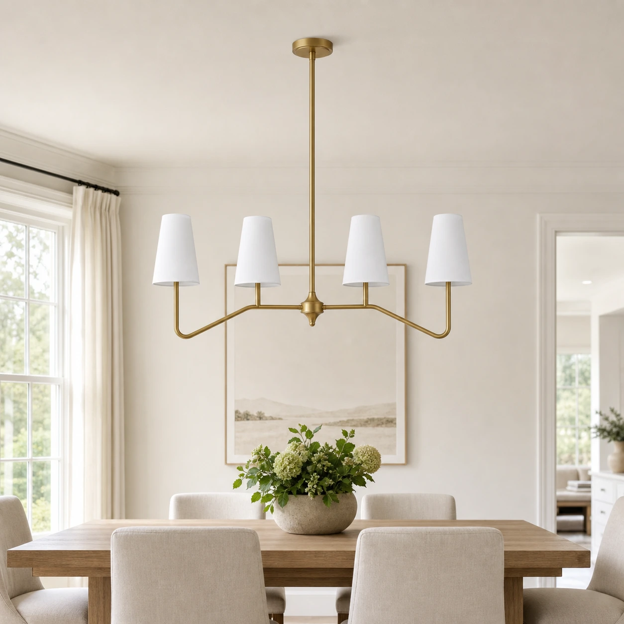 Strellux brass linear chandelier above a dining table